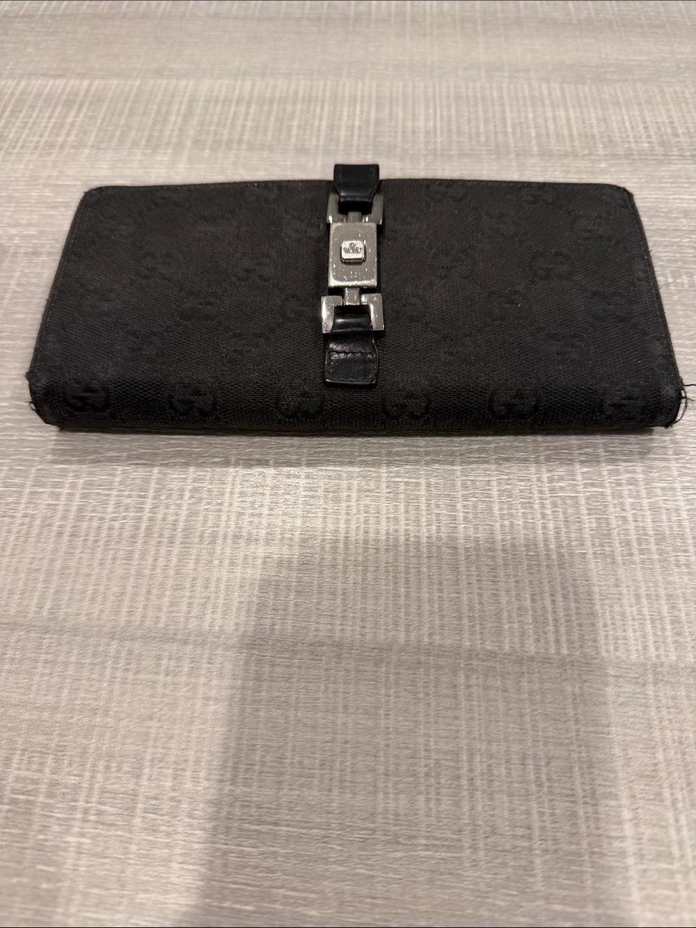 Authentic Gucci Black Signature Canvas Long Wallet with Silver Buckle.
